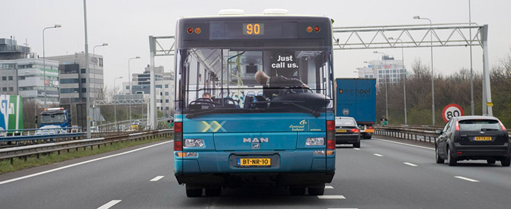 Centraal Beheer Man Driving Backwards Bus Wrap